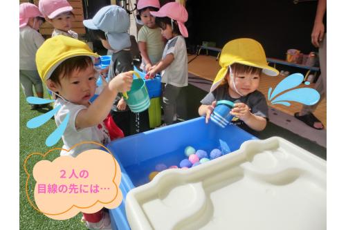 まずはこの<span style='color:#0000ff;'>水がためる</span>ことができるテーブル！<br><br><span style='color:#ff7f00;'>ひよこチーム（０歳児）</span>には高さもぴったりで<br>小さなバケツに水を入れたりジャーっと流したり…<br><br>そんな子ども達の<span style='color:#00ff00;'>視線</span>の先は？<br>